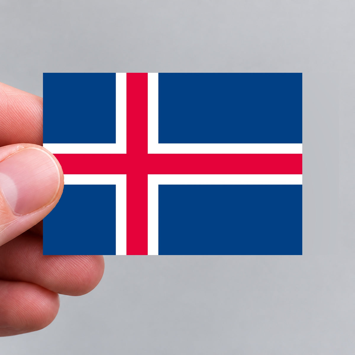 A hand holding an Icelandic flag sticker by Gobrecht & Ulrich