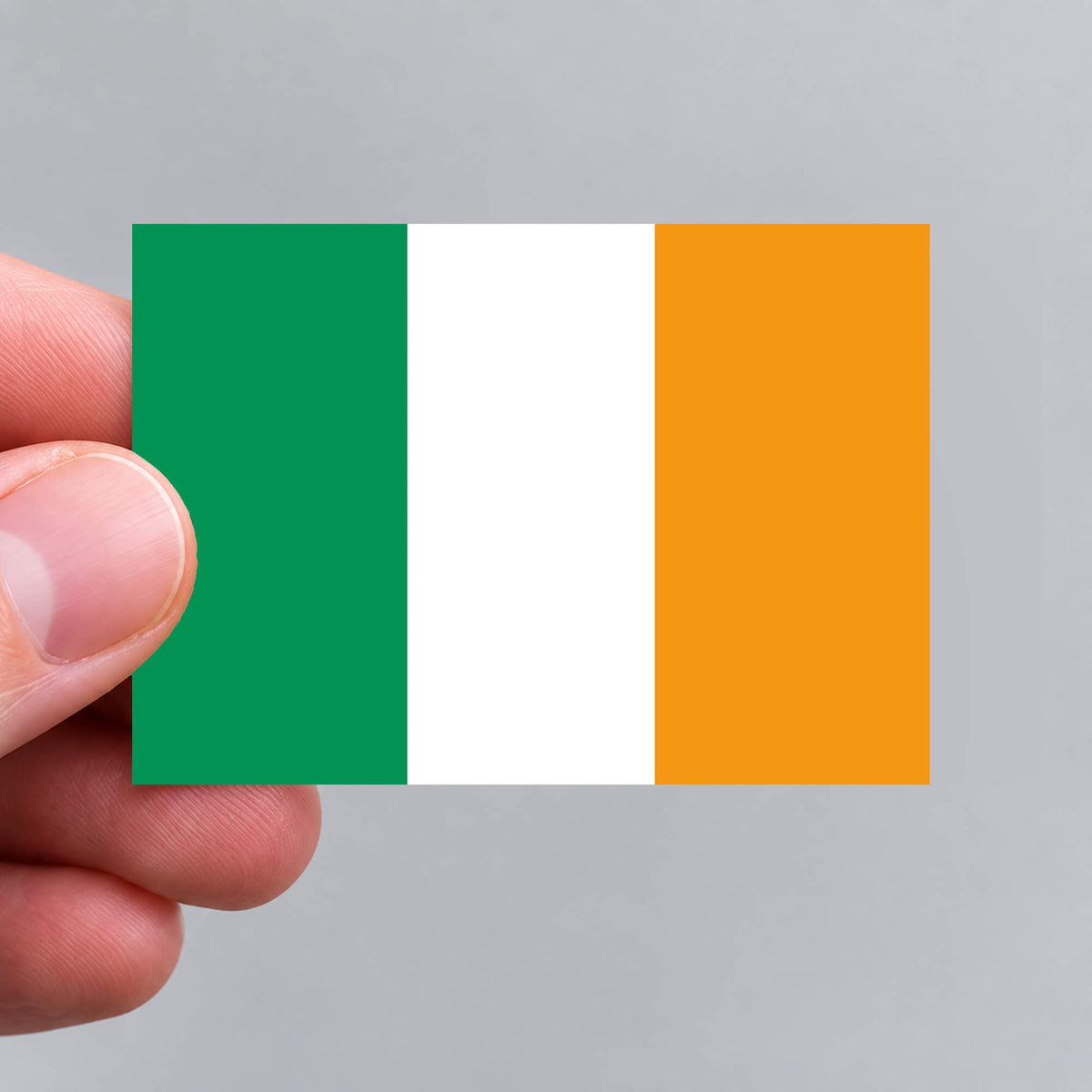 A hand holding an Irish flag sticker by Gobrecht & Ulrich