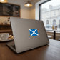 Laptop with a Scottish flag sticker on a table in a cafe