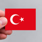 A hand holding a Turkish flag sticker by Gobrecht & Ulrich