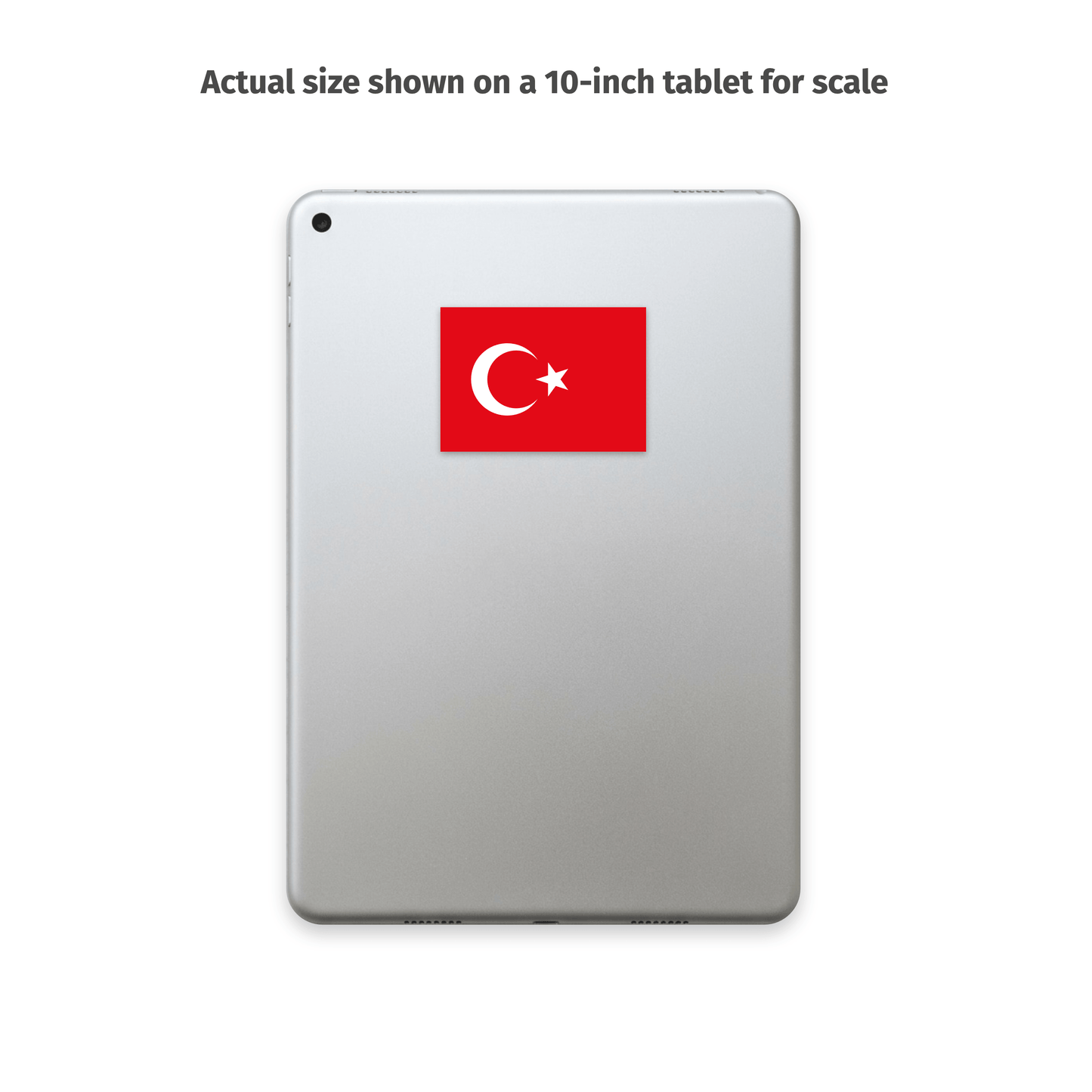 A silver tablet on a white background with text above reading 'Actual size shown on a 10-inch tablet for scale.' The tablet displays a red square sticker featuring a white crescent and star, the Turkish flag.