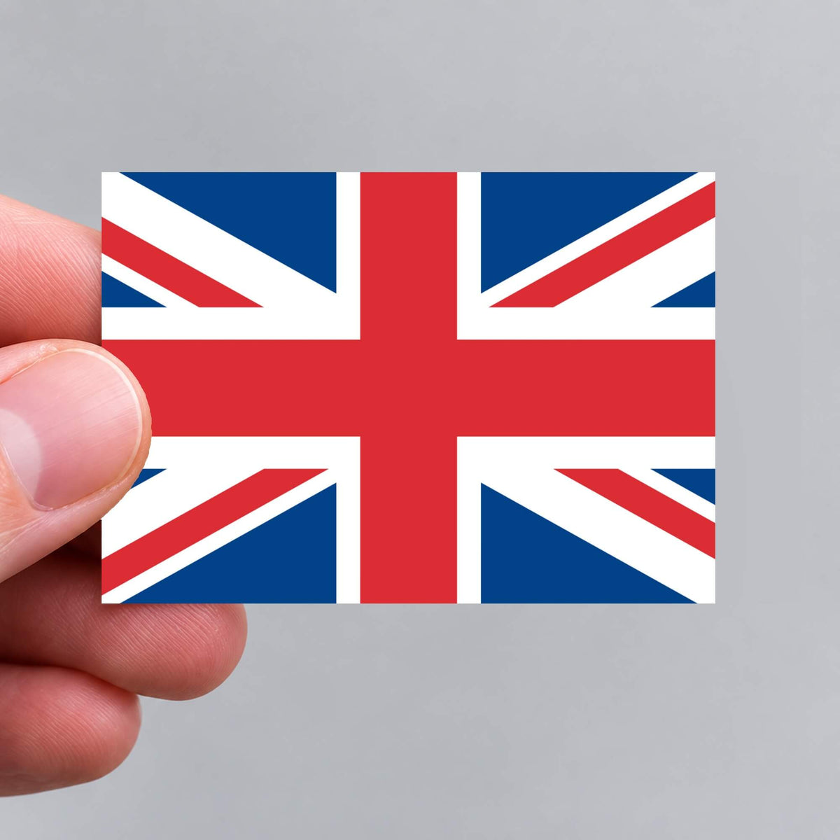 A hand holding a Union Jack sticker by Gobrecht & Ulrich