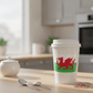 Welsh flag vinyl sticker on a reusable takeaway coffee cup on a kitchen counter