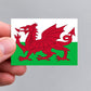 A hand holding a Welsh flag sticker by Gobrecht & Ulrich