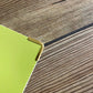 Gold Softcover Book Corner Protectors used on a softcover book / folder 