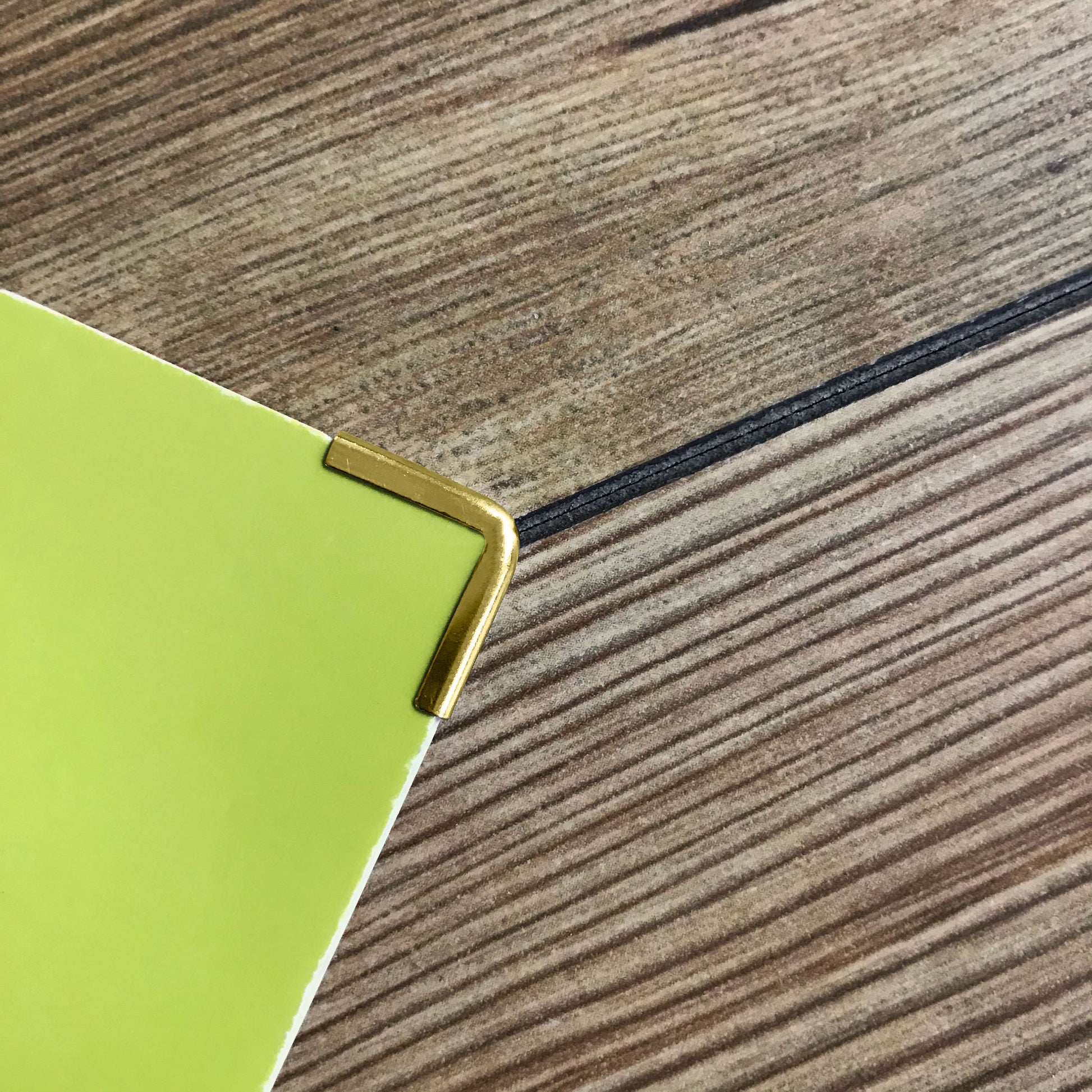 Gold Softcover Book Corner Protectors used on a softcover book / folder 