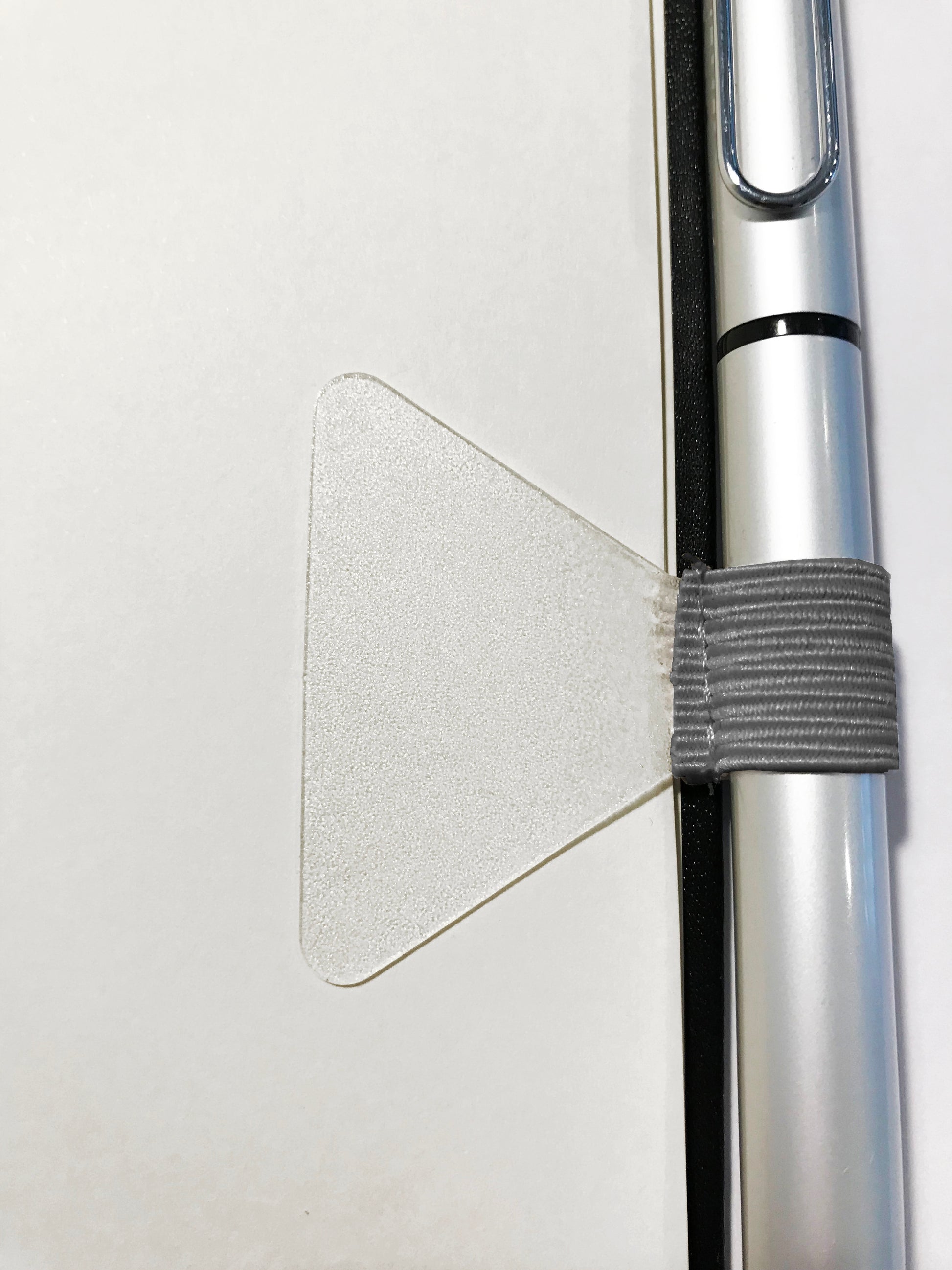 Gobrecht & Ulrich Grey Self-adhesive Pen Loop applied to notebook