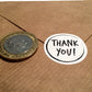 Size comparison thank you sticker and £2 coin